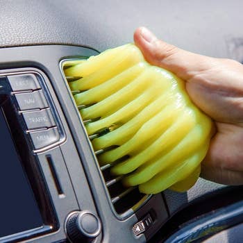 Hand pressing the gel on car air vents