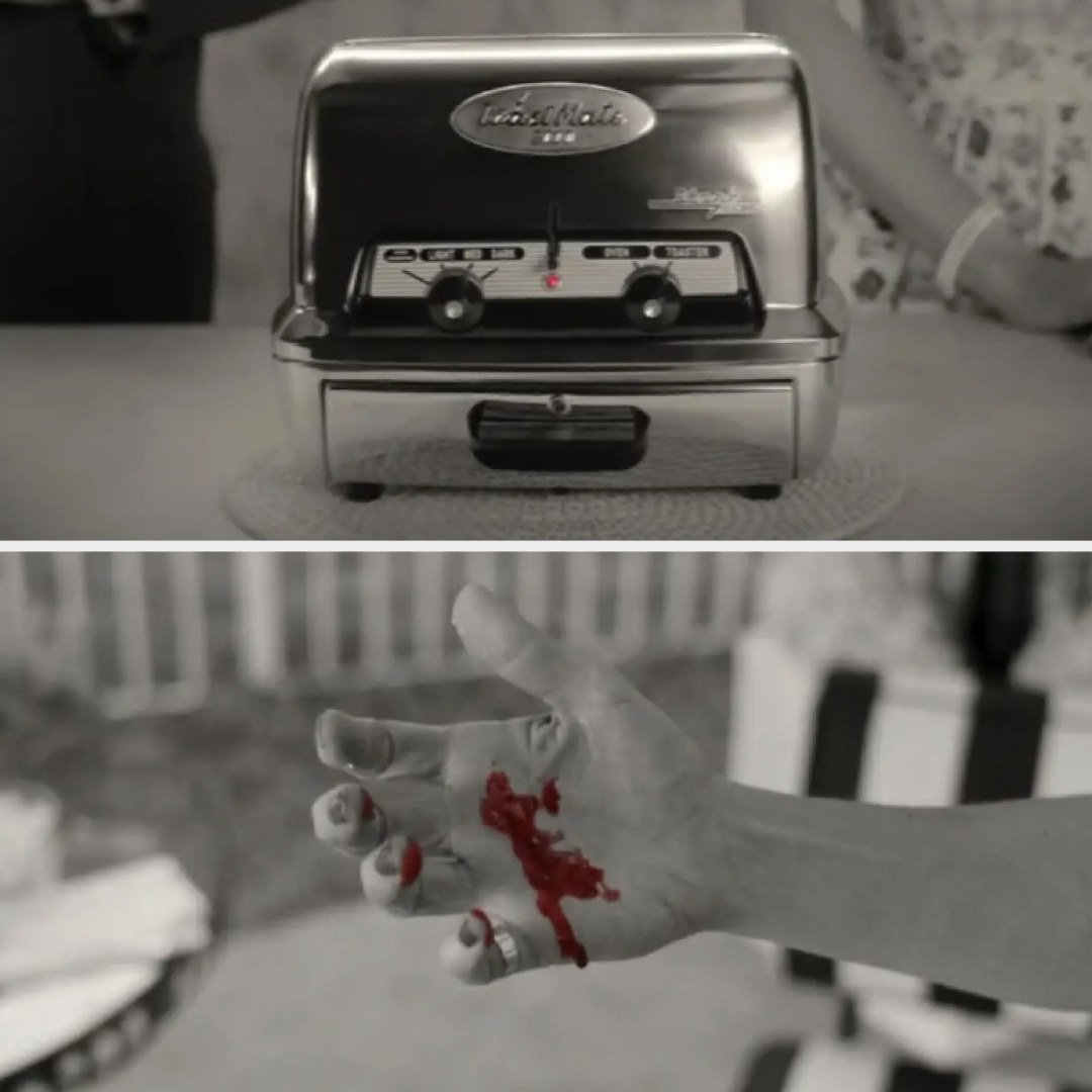 Black and white toaster with red blinking light and black and white hand with red blood