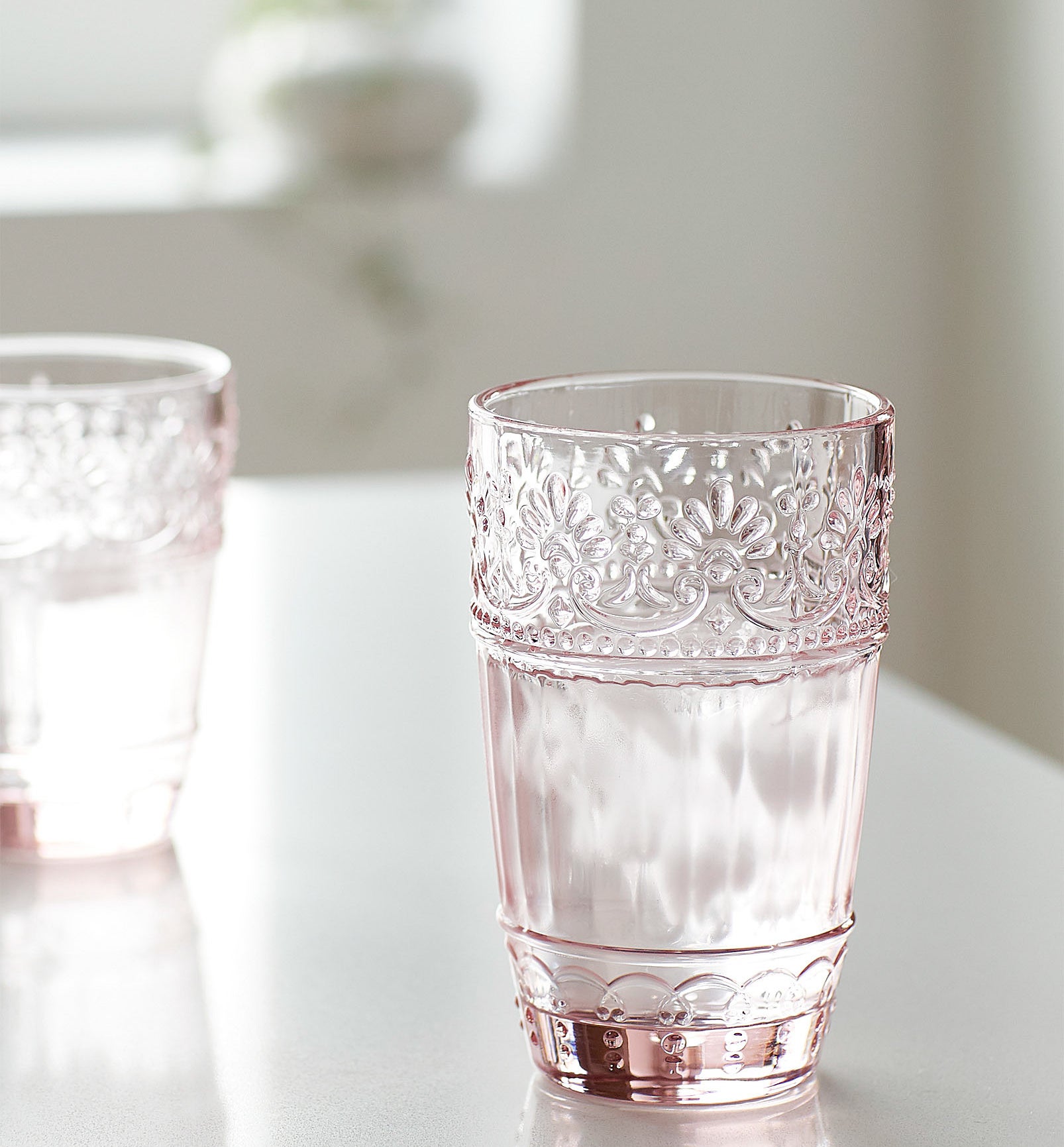 A rosy glass with a floral trim 