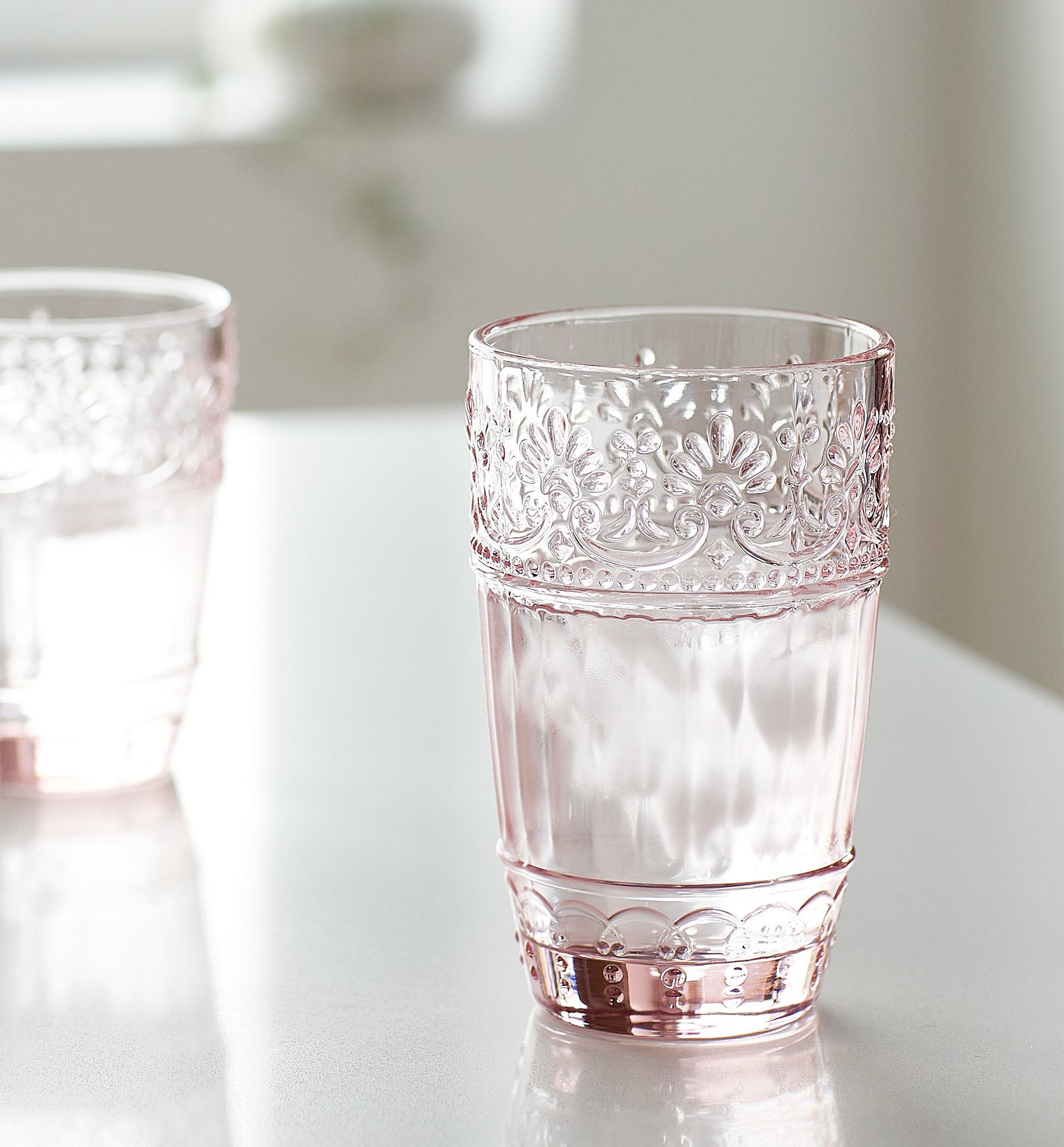 A rosy glass with a floral trim 