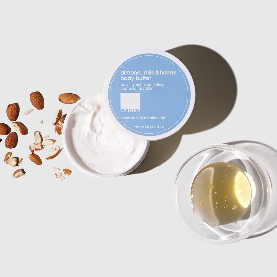 an open jar of hand cream with almonds and honey next to it