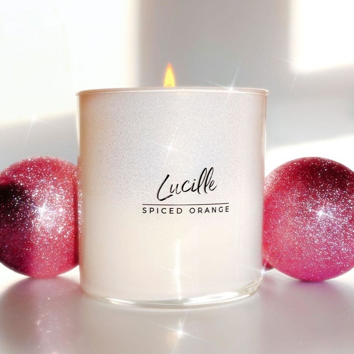 White candle that says Lucille in black 
