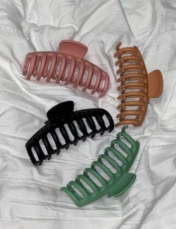 reviewer photo of four claw clips lying on a white surface