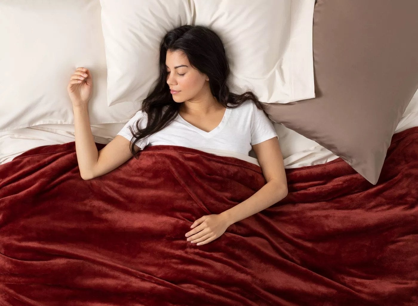 women in bed with weighted blanket