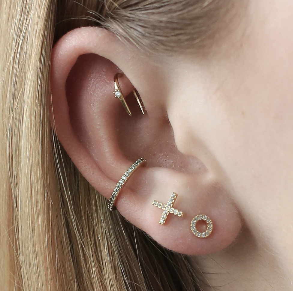 model wearing x and o pave ear studs