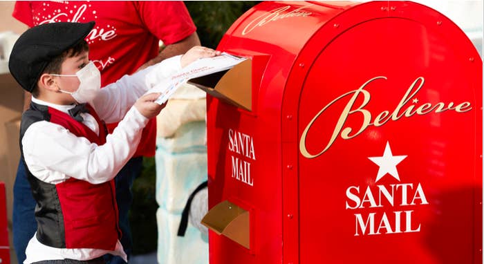Mateo delivering letters to mailbox labeled &quot;Santa Mail&quot;