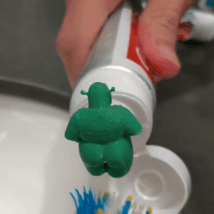 a gif of toothpaste coming out shrek's butt