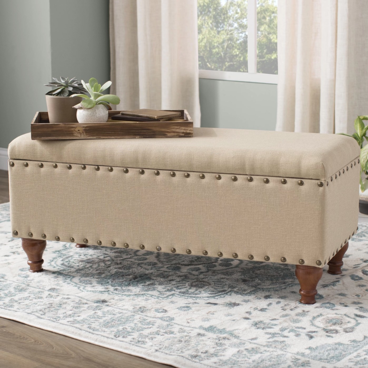 The upholstered flip top storage bench in tan