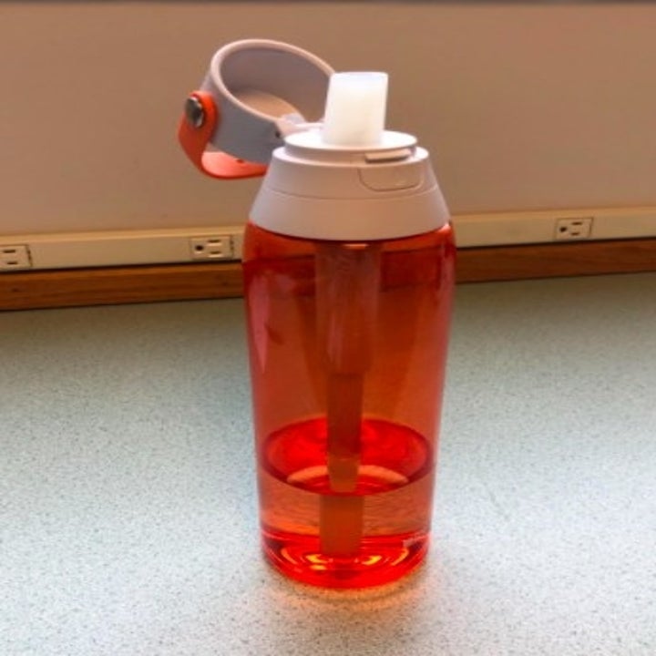 orange brita water bottle with the lid open and the straw up