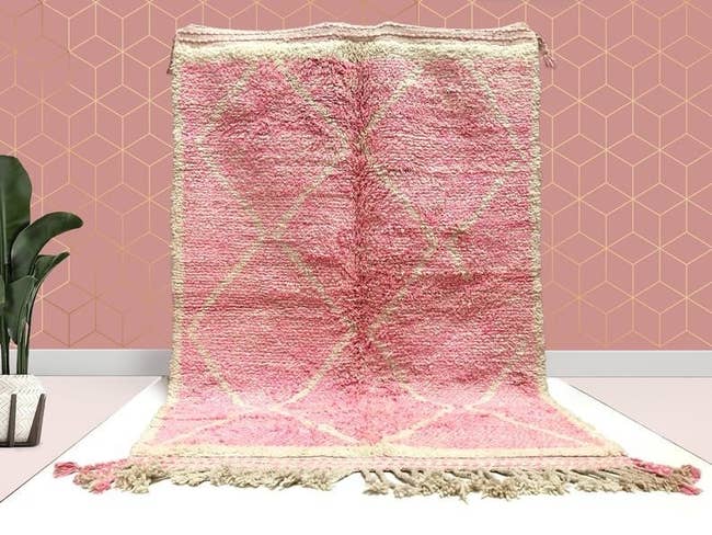 The pink rug with fringe
