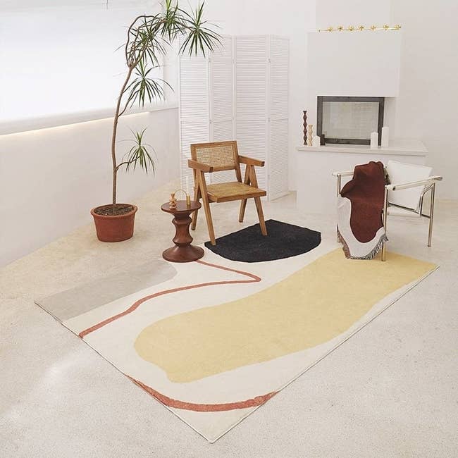 Cream rug with fringe and black geometric design