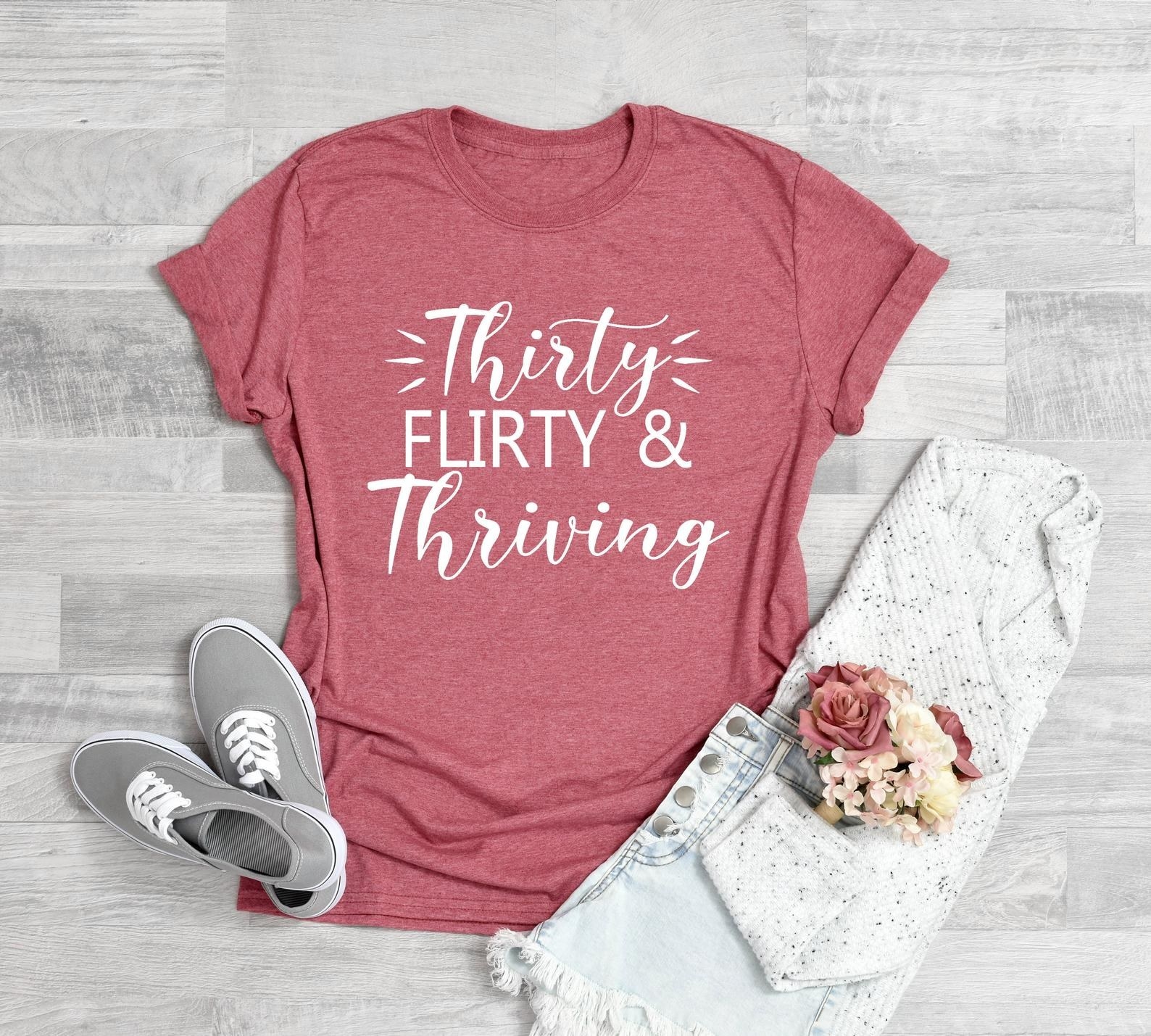 Coral pink T-shirt with words in white 