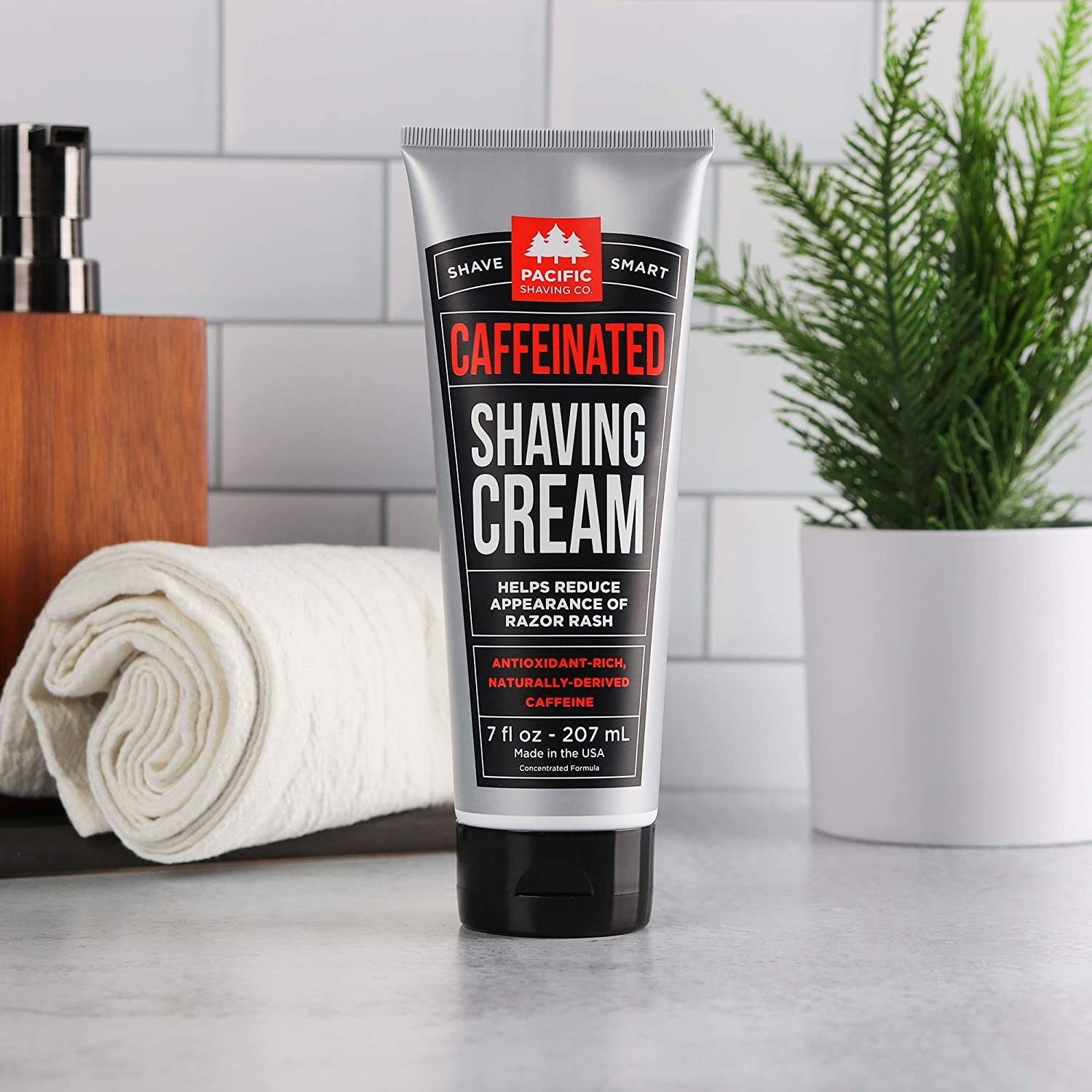 A tube of caffeinated shaving cream on a bathroom vanity