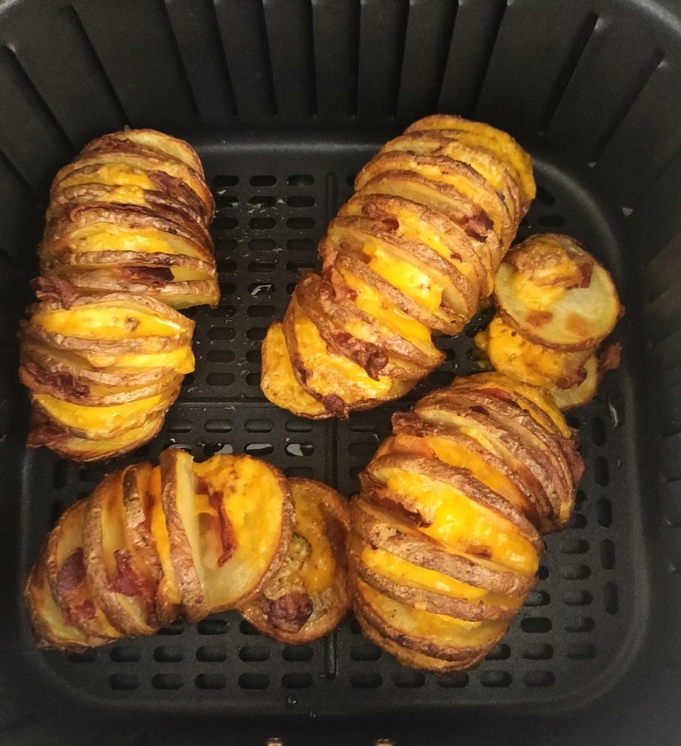 Air fryer hasselback potatoes with cheese and bacon.