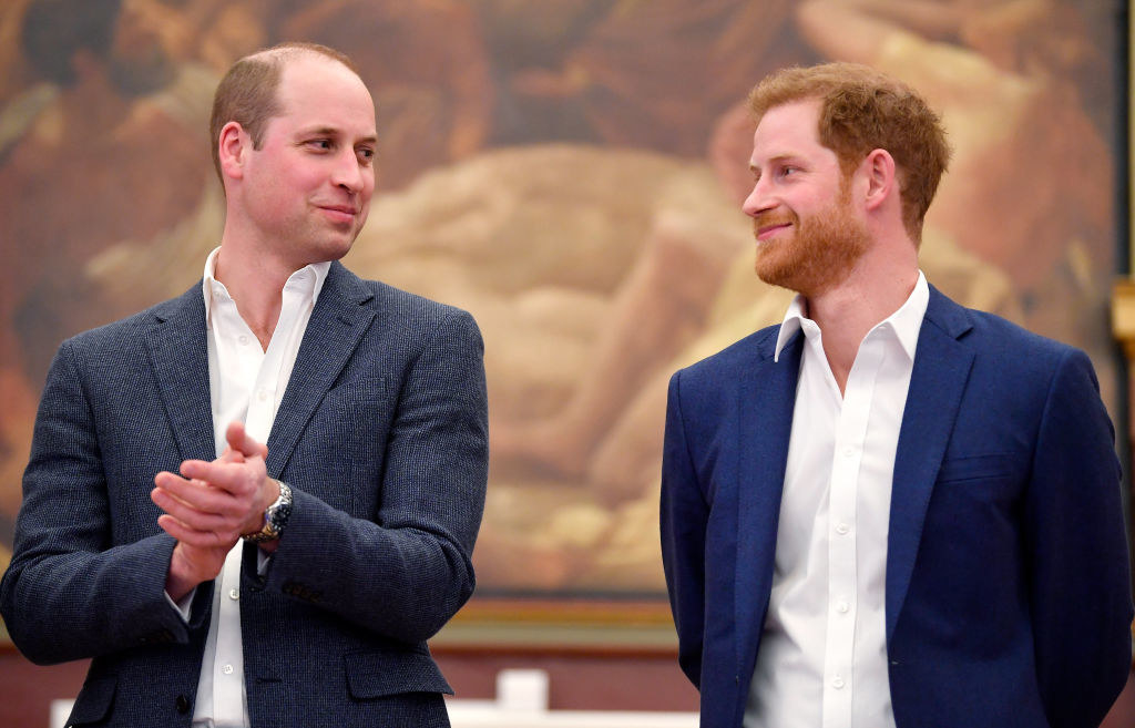 William and Harry smiling at one another during happier times