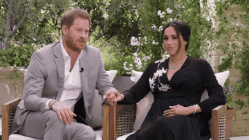 Meghan turns her head while sitting with Harry during the interview