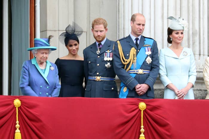 Meghan and Harry stand with the Queen, William and Kate Middleton at an event