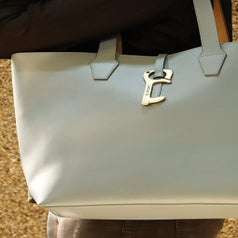 A brass key attached to a bag 