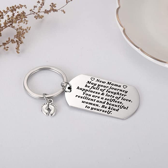 silver keychain tag that says, &quot;New mama. May your journey be full of laughter and happiness and lots of love. You are a selfless, resilient, and beautiful woman. Be kind to yourself.&quot;
