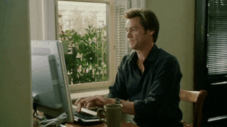 A gif of Jim Carrey from Bruce Almighty typing super fast on a computer keyboard