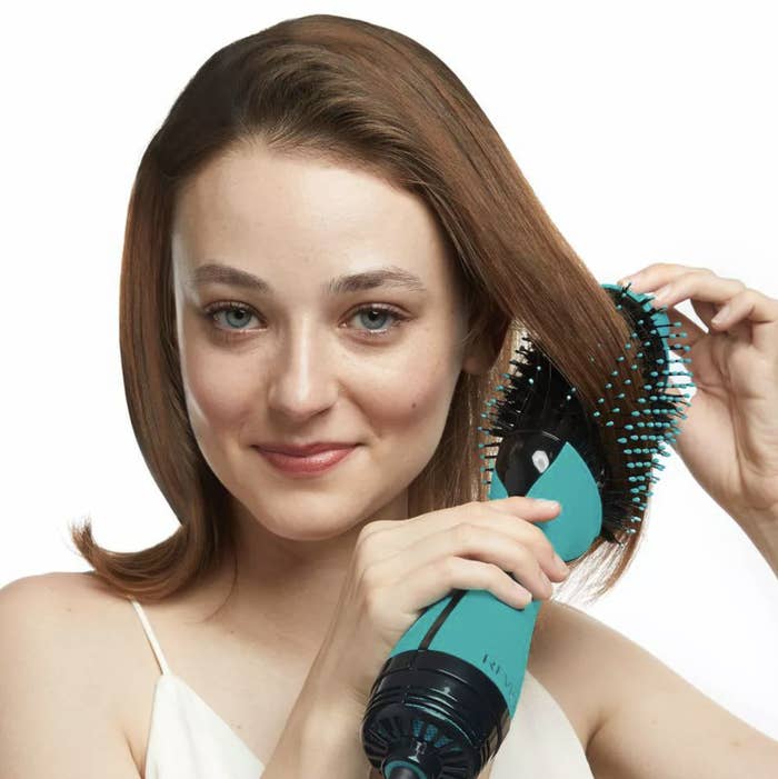 a model using the blue blow dryer brush