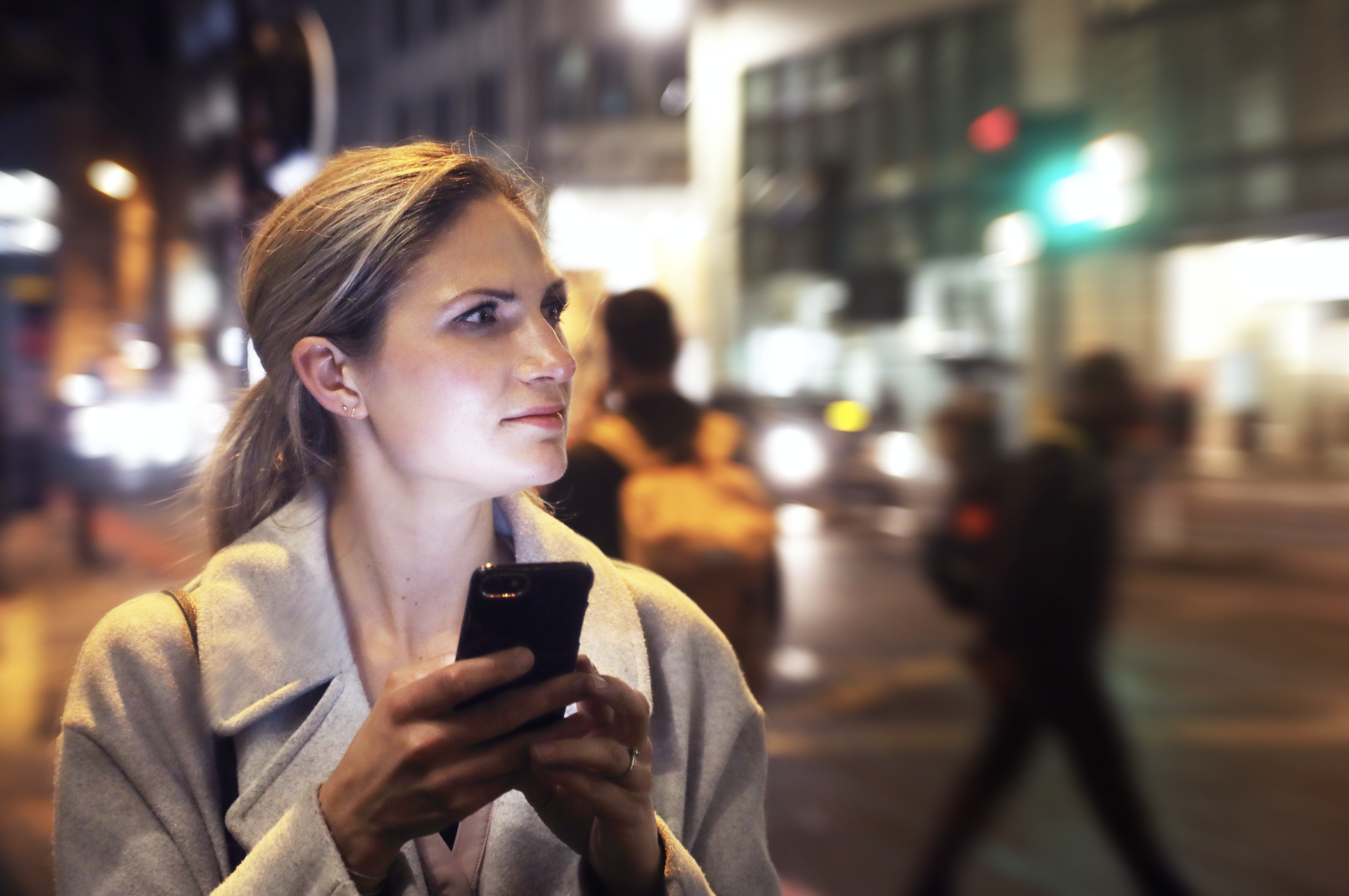 A woman receiving a text and making an uncomfortable face