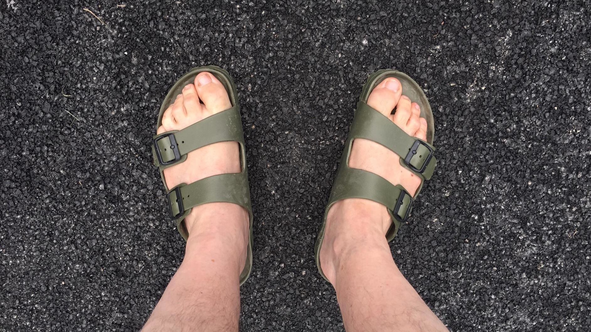 reviewer wearing the sandals in green