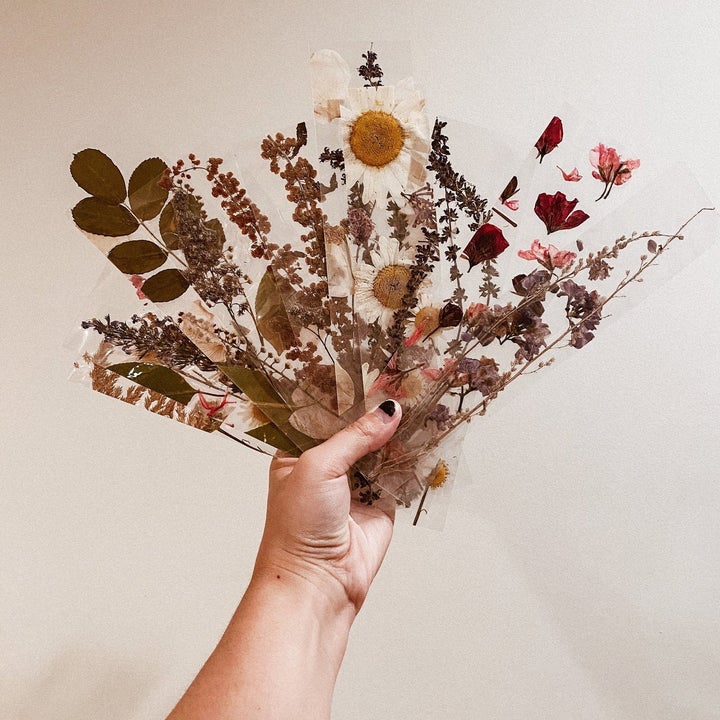 hand holding the flower bookmarks 