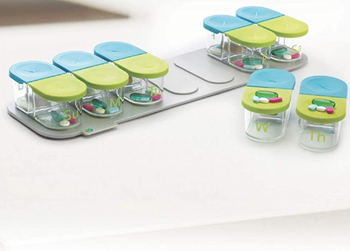 the pill organizer with slots for night and day of each day of the week that can be removed from the base 