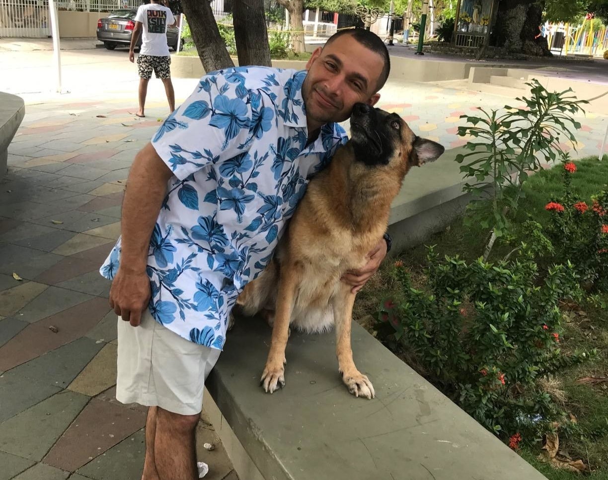 reviewer wearing the short sleeve button down with a dog next to them 