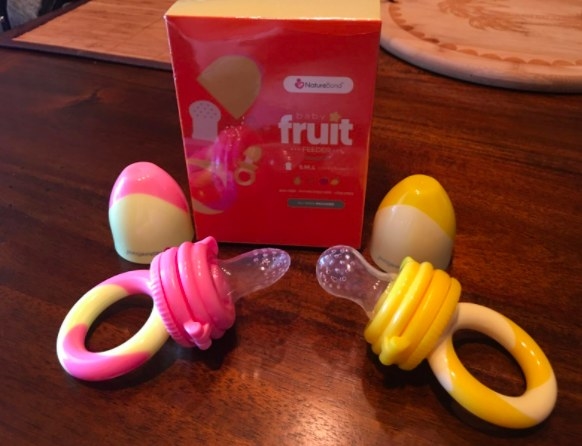 two pacifier food feeders sitting on the table