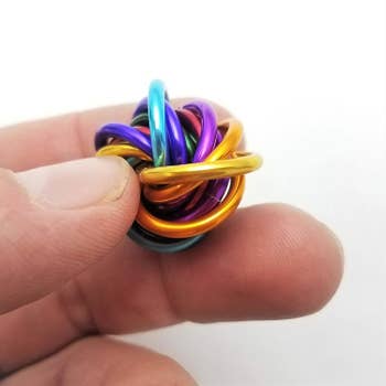 rainbow circular fidget toy in hands
