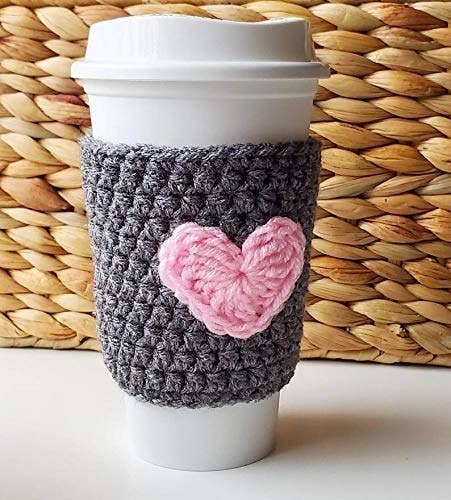 gray sleeve with a heart on white to-go disposable coffee cup