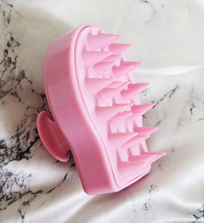 A silicone brush with pointy bristles and a thick handle
