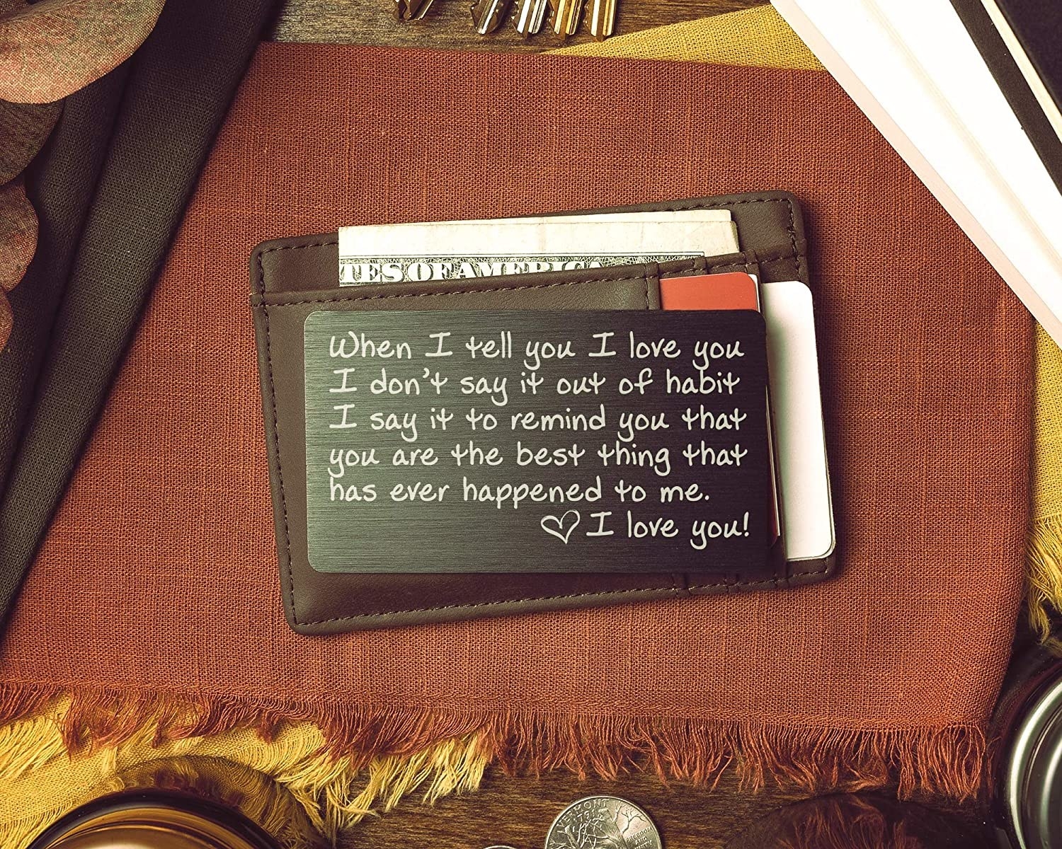 engraved black-and-white love note on top of brown wallet