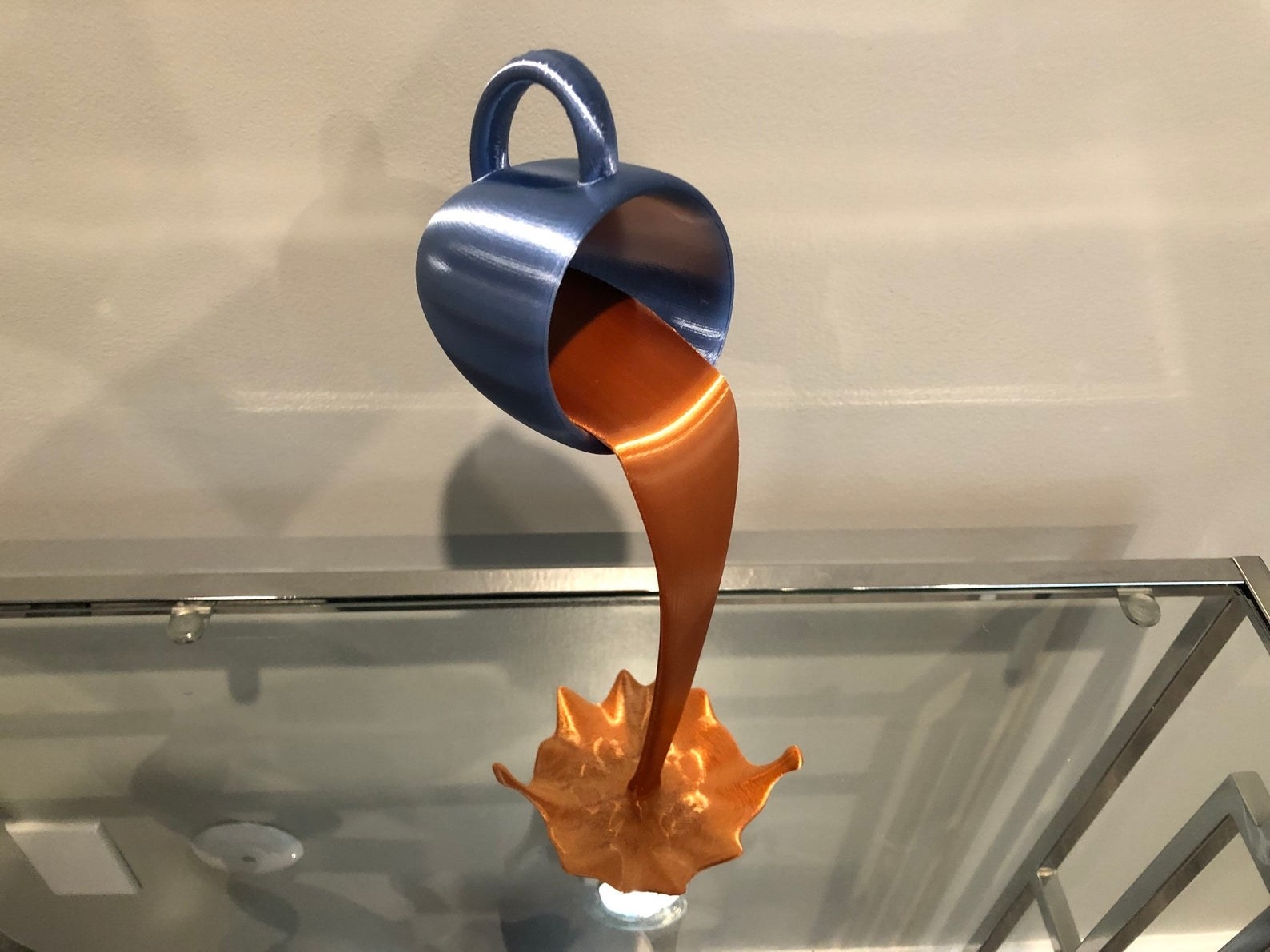 Floating coffee cup figure placed on glass table