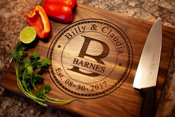 the wooden cutting board with a knife and veggies that says &quot;Billy and Claudia Barnes&quot;