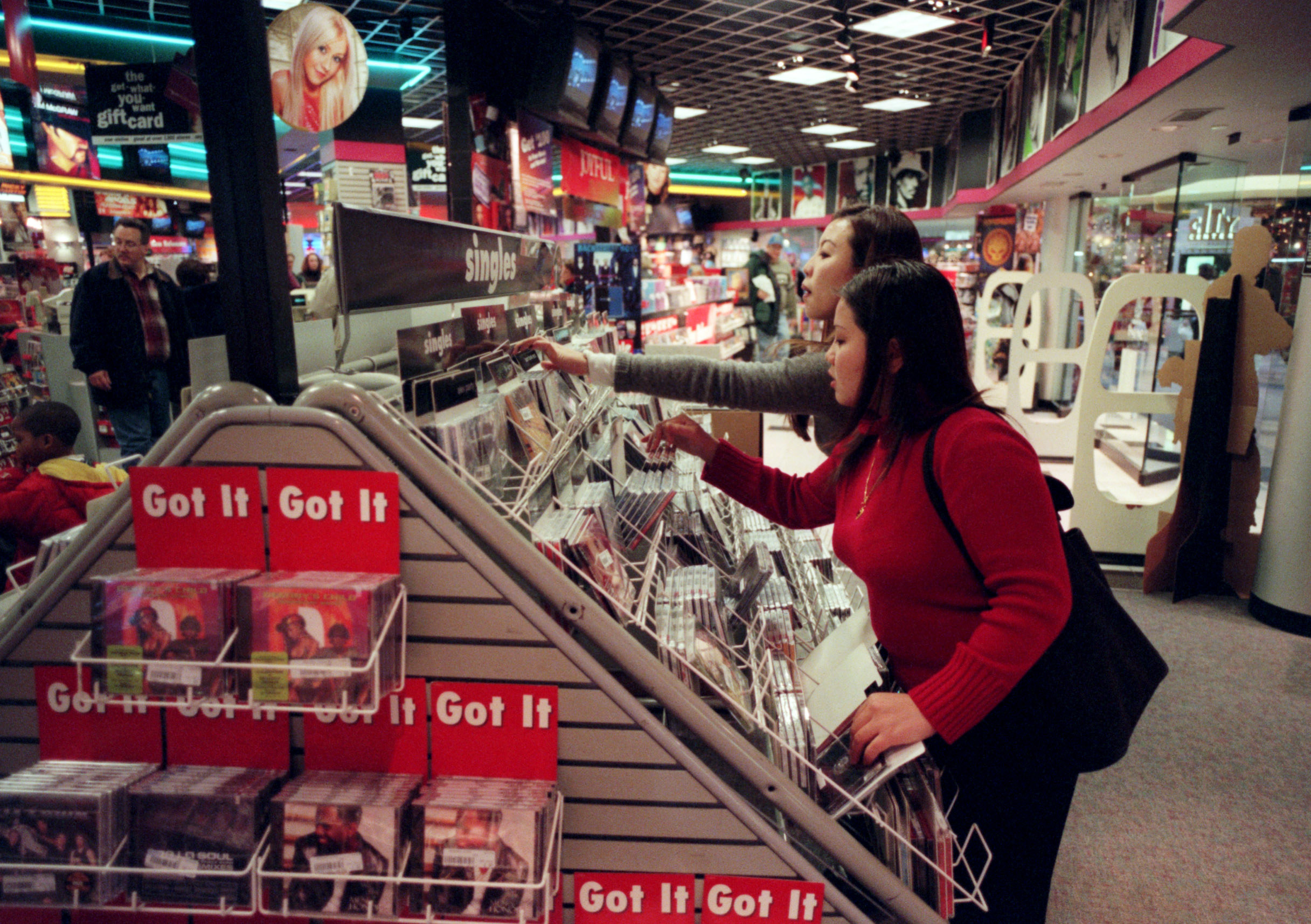 Two woman looking for CDs at Sam Goody&#x27;s 