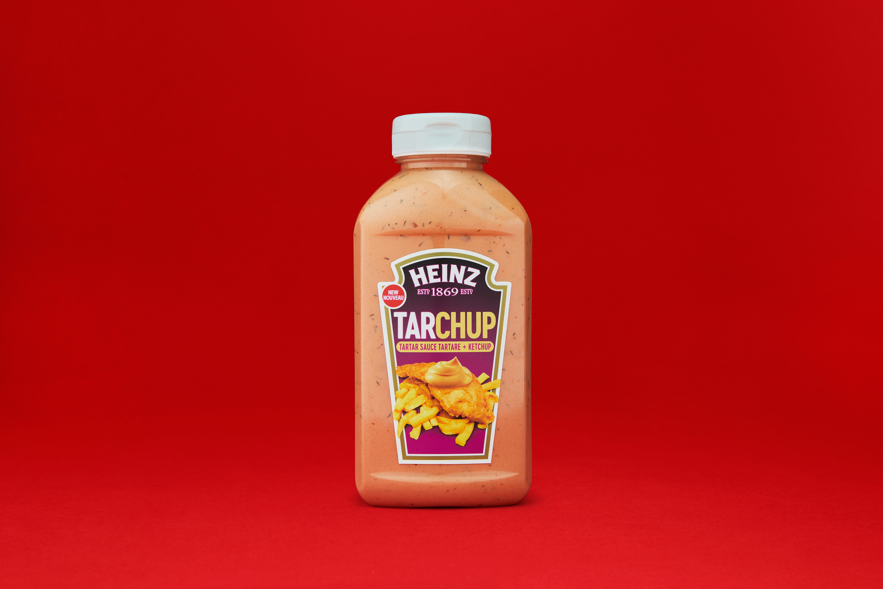 A bottle of Tarchup sauce on a red backdrop.