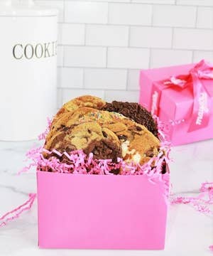 pink box filled with assorted cookies