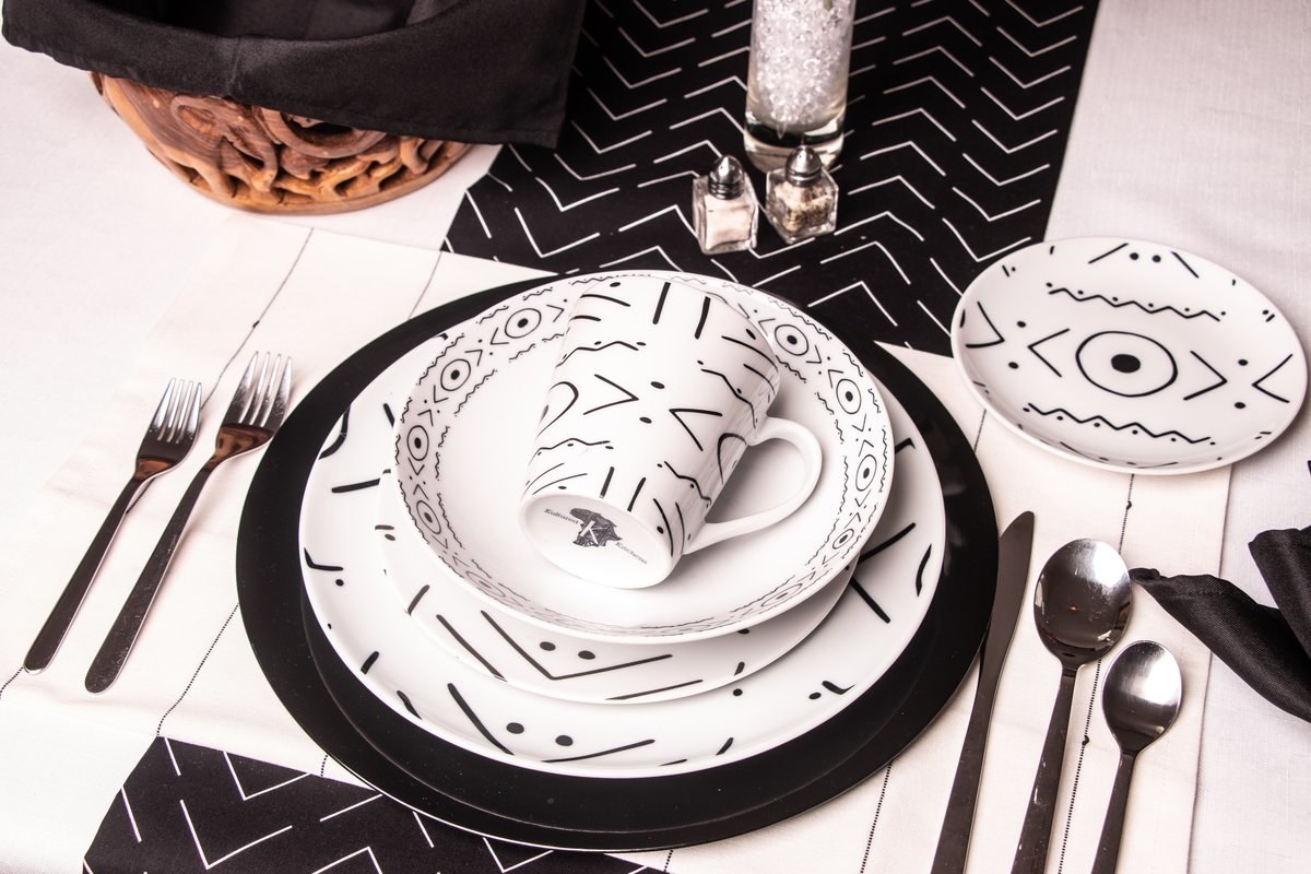 set of dinnerware in white with black graphic design all over them
