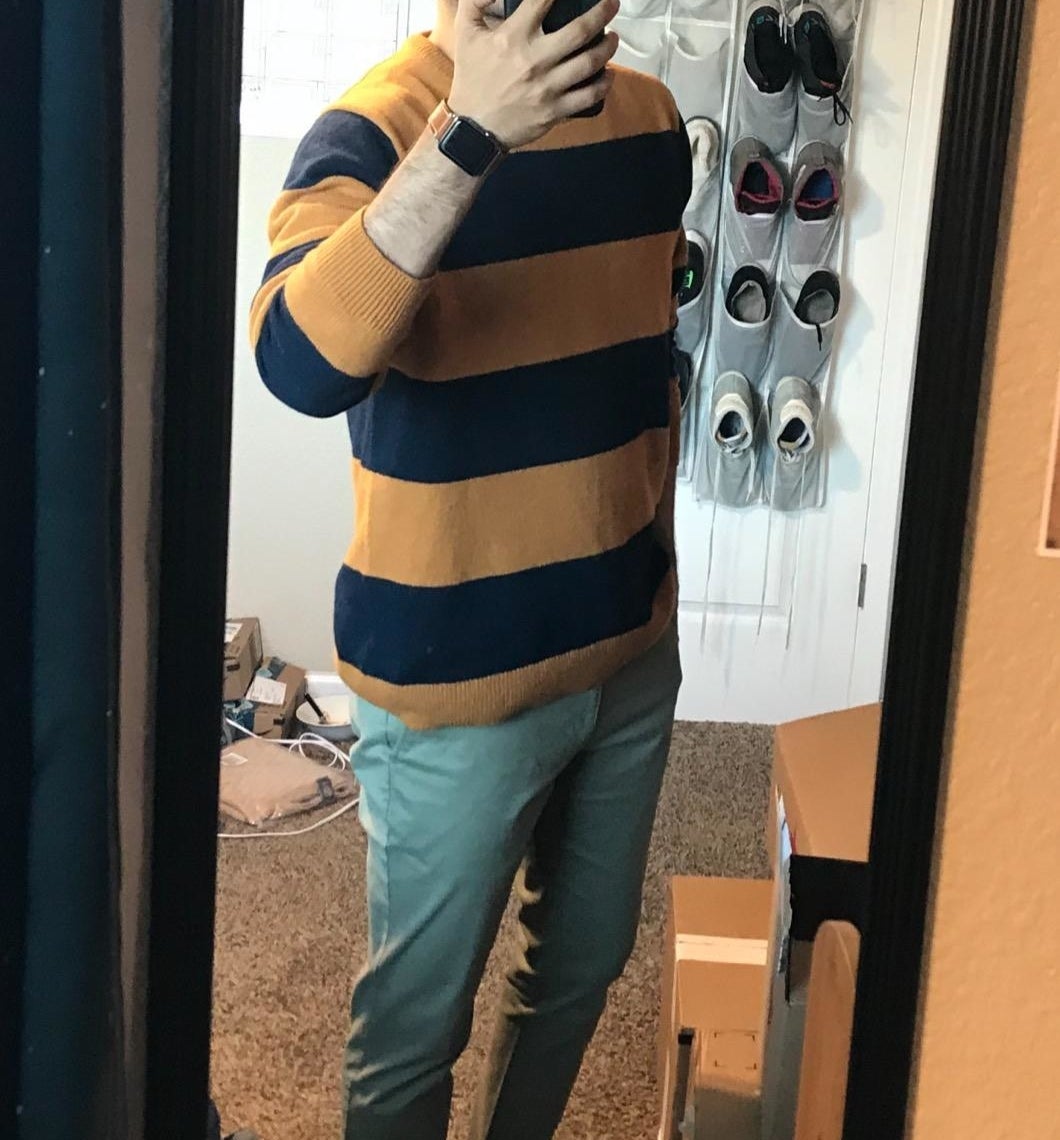 reviewer mirror selfie while wearing the striped sweater