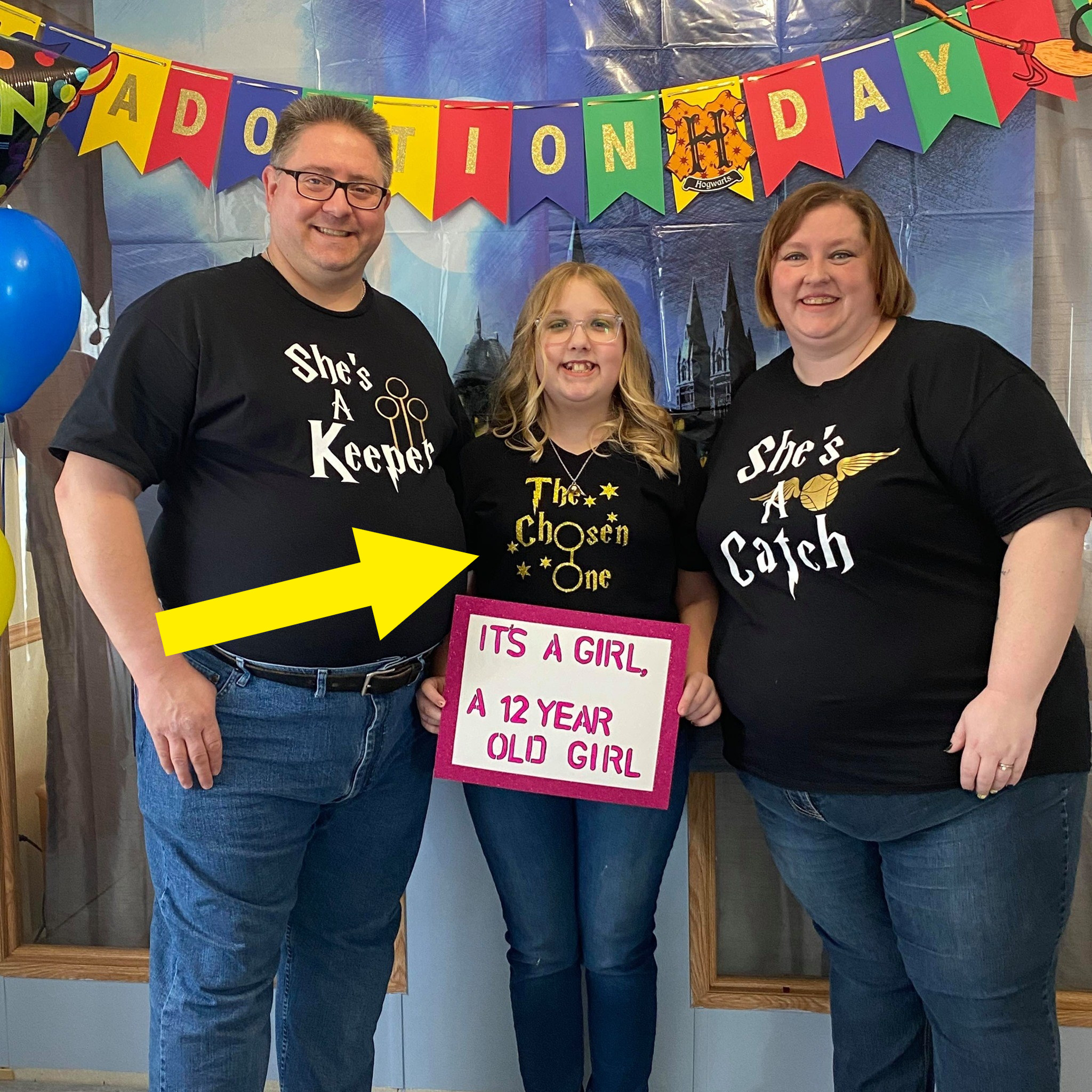 The Fontaines posing together on adoption day in their Harry Potter shirts