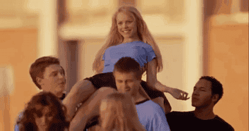 Regina George being carried by classmates 