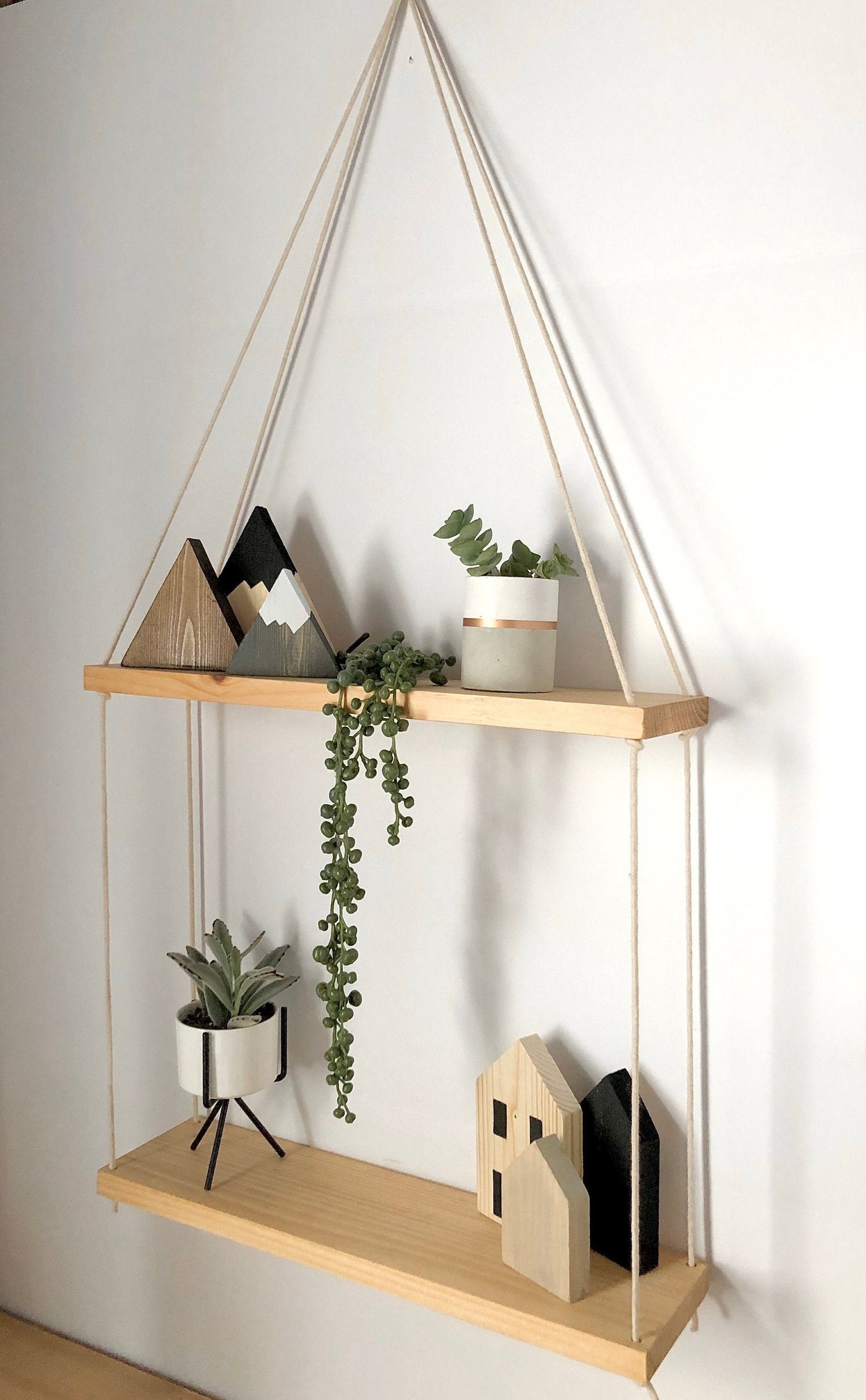 Two-tiered hanging shelf hanging on wall