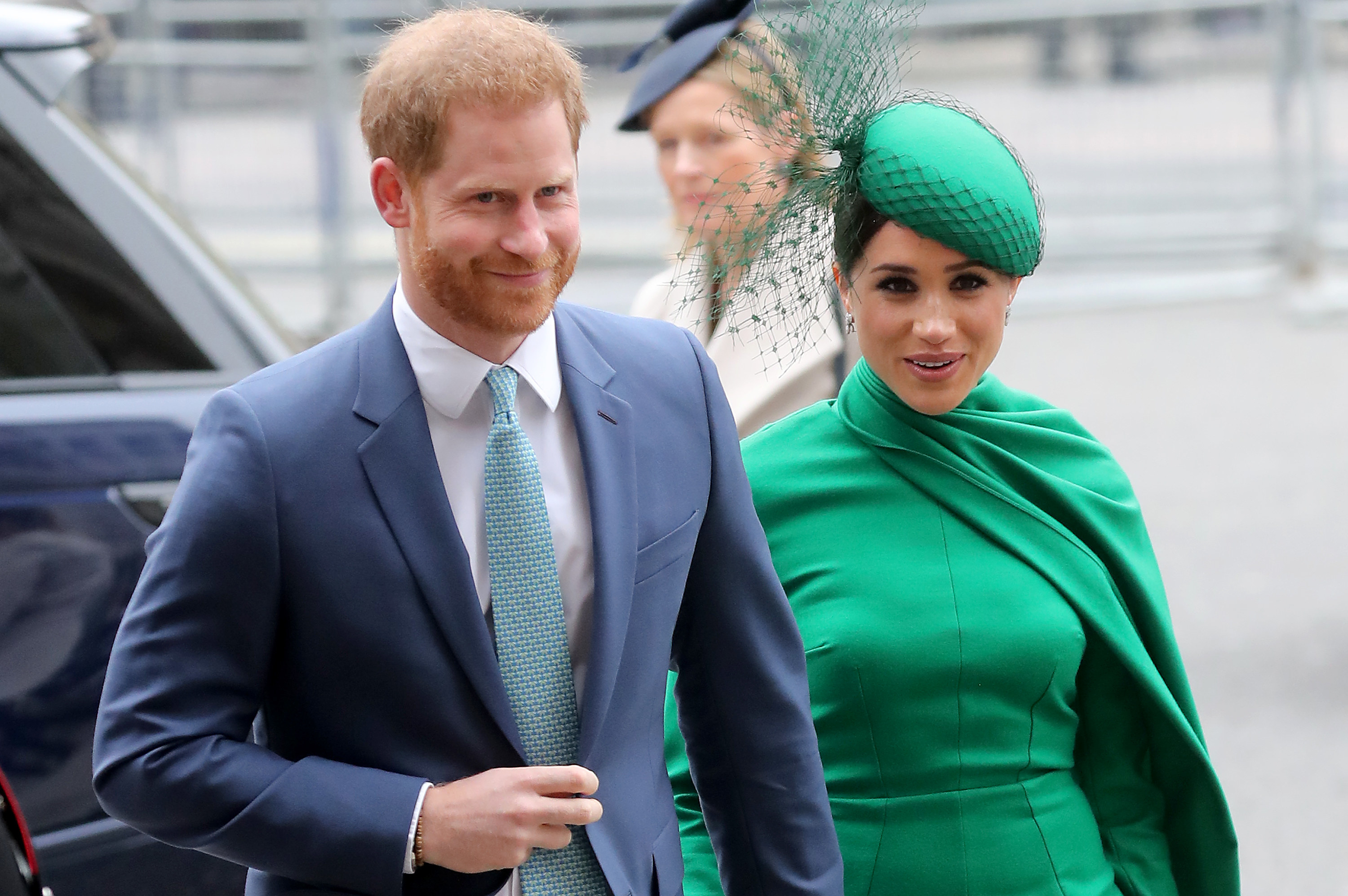 Meghan wears a formal green outfit while heading to an event with Harry