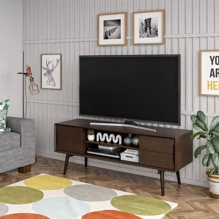 Walnut television stand with TV on top