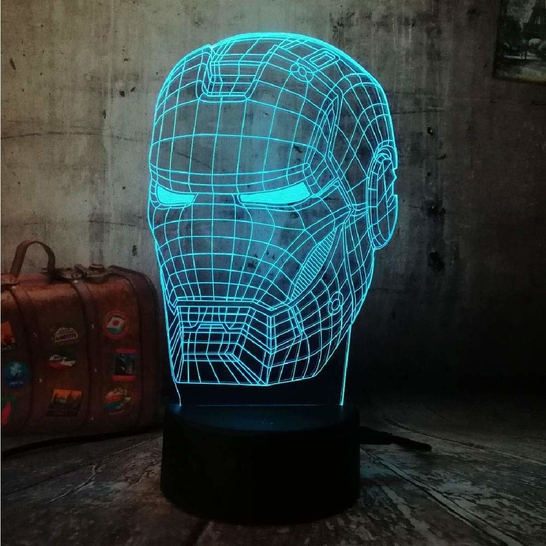 A lamp that has a glowing wireframe in the shape of Iron Man&#x27;s helmet. The wireframe gives it the illusion of being a hologram.