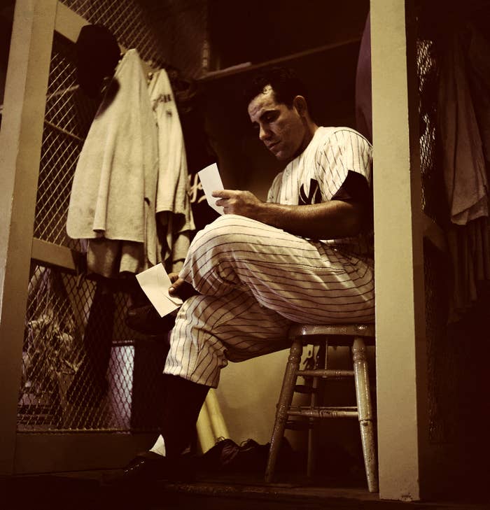 Yogi Berra reading letter in Yankees' locker room