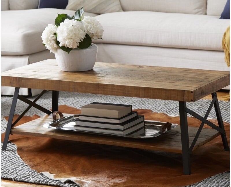 Coffee table with two wooden layers and a black metal frame